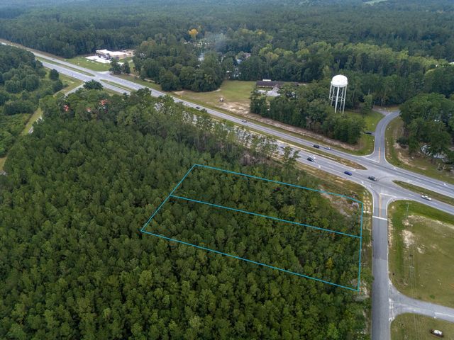 Aerial view looking southwest across the site toward GA Hwy 21 Bypass, with both parcels outlined and W First Street Extension on the right