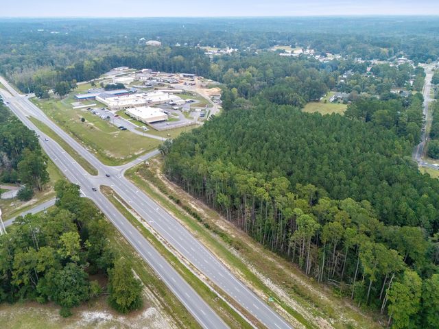 High aerial view looking northeast across GA Hwy 21 Bypass to the site and the W First Street Extension intersection, no boundary lines shown